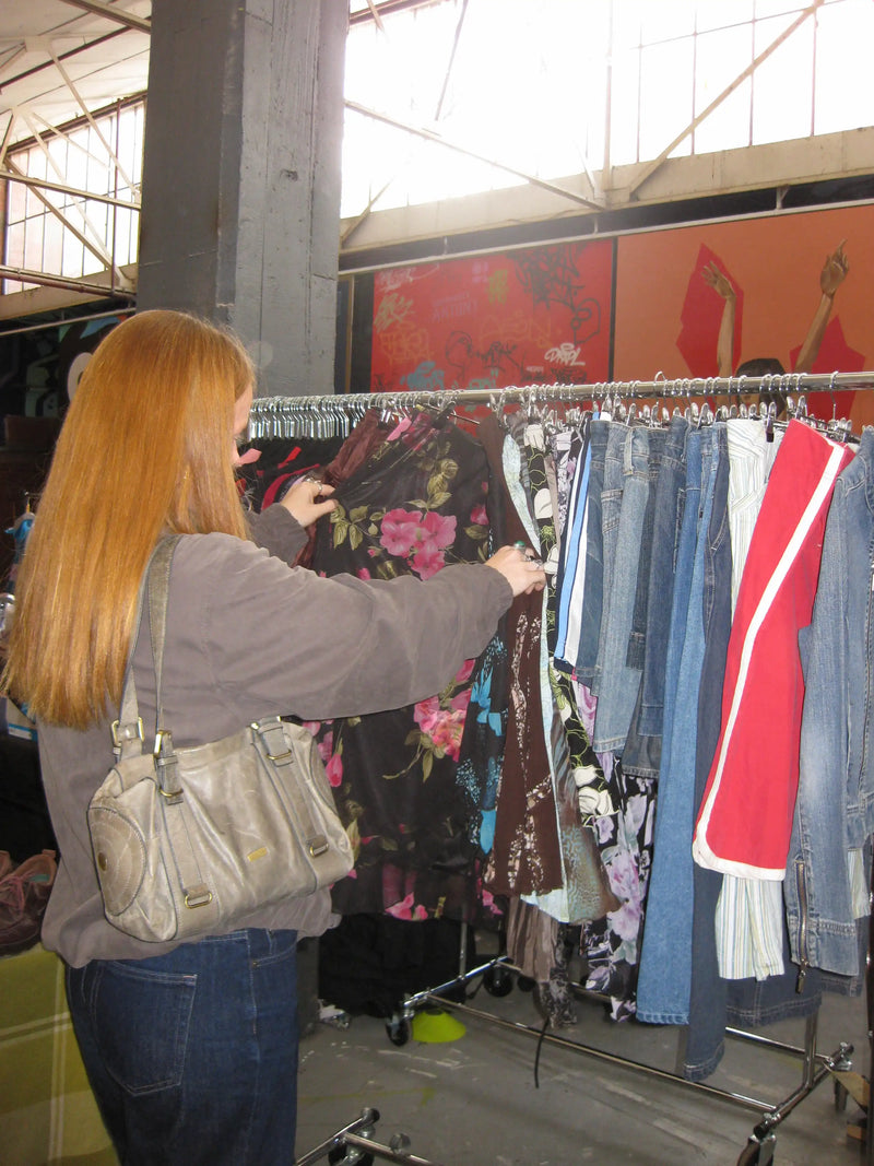 Customer looking through a rack of vintage skirts