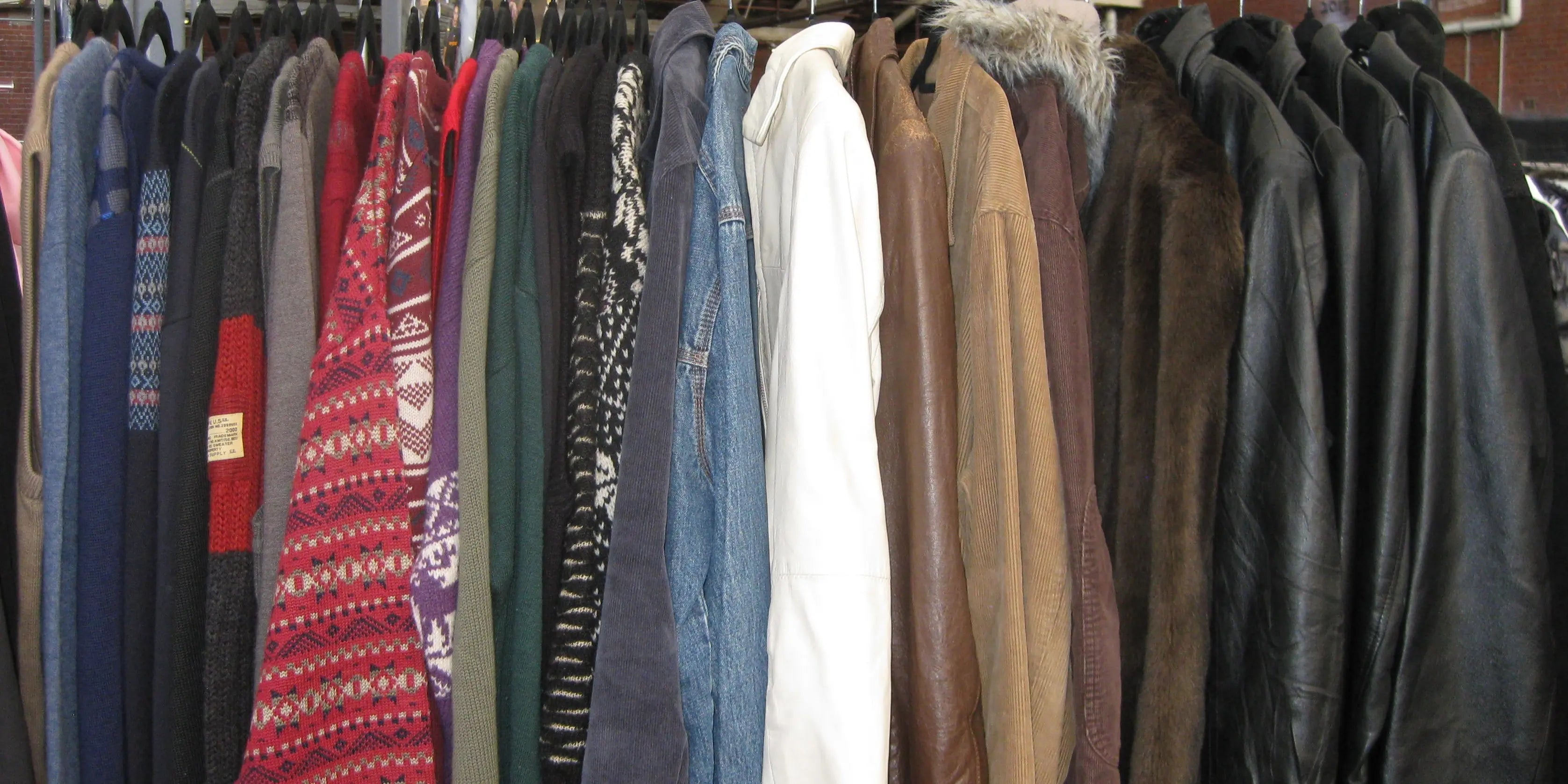 Vintage faux fur jackets on a rack with some other vintage jackets