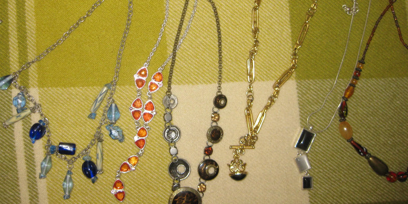 Vintage necklaces sitting on a table
