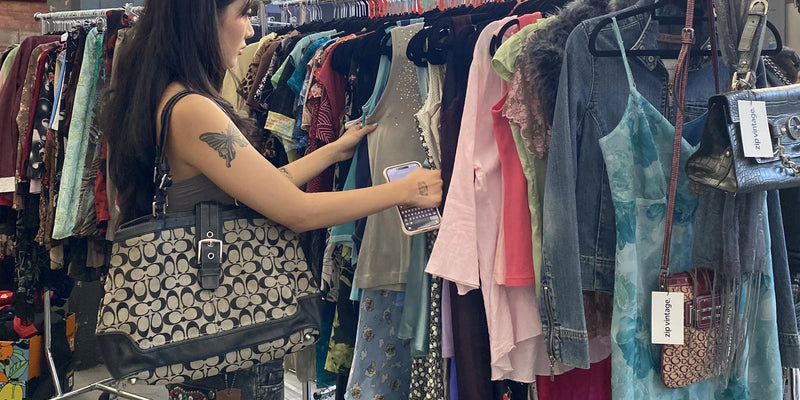 Customer looking through a rack of vintage sleeveless tops