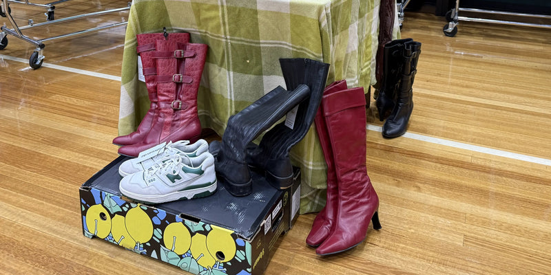 Vintage white sneakers on display with some boots