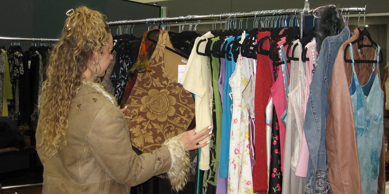 Customer looking through a rack of vintage tank tops