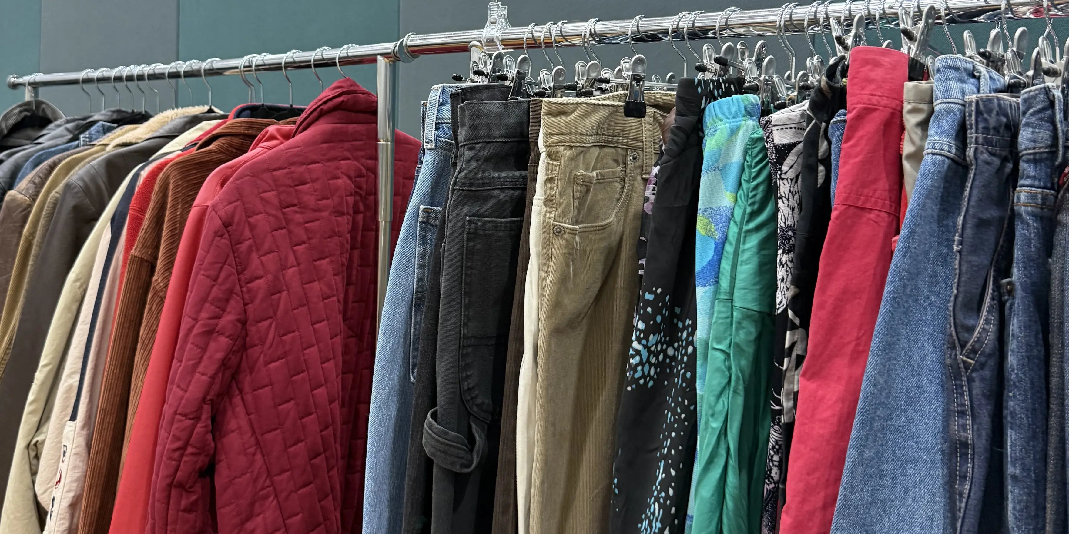 A rack of vintage clothing including some vintage shorts