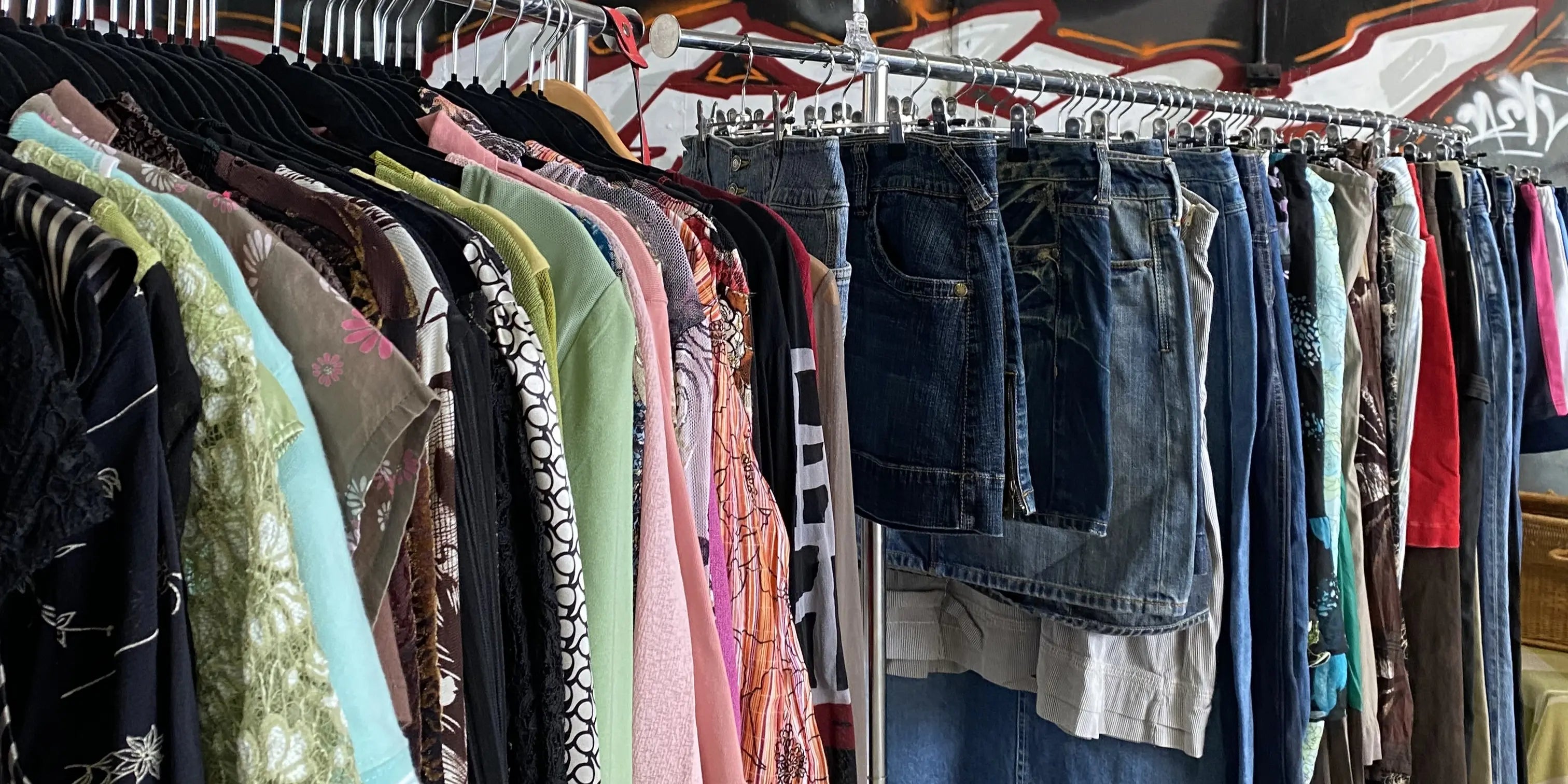 Vintage maxi skirts next to a rack of vintage tops