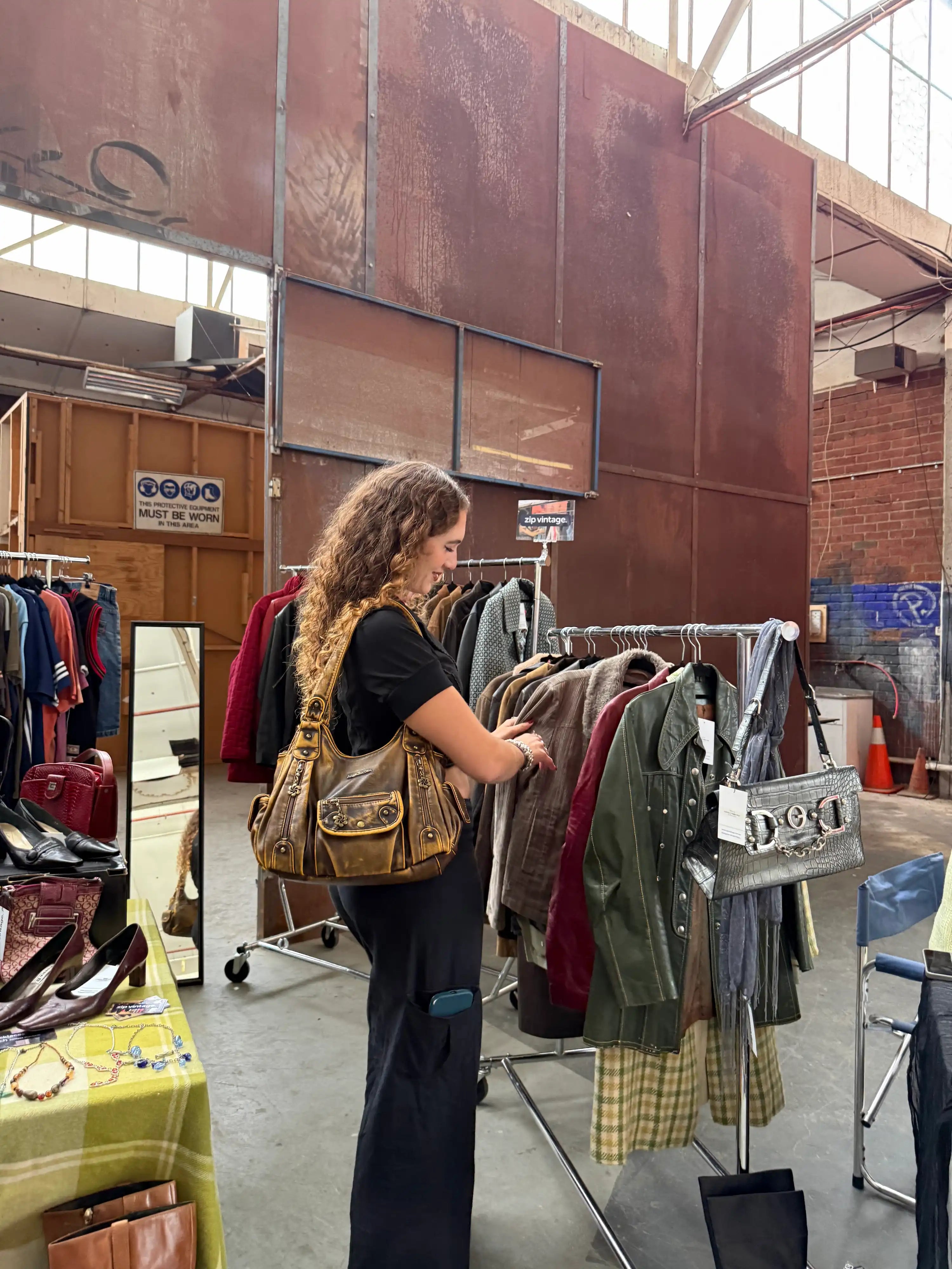 Customer looking at rack of vintage jackets