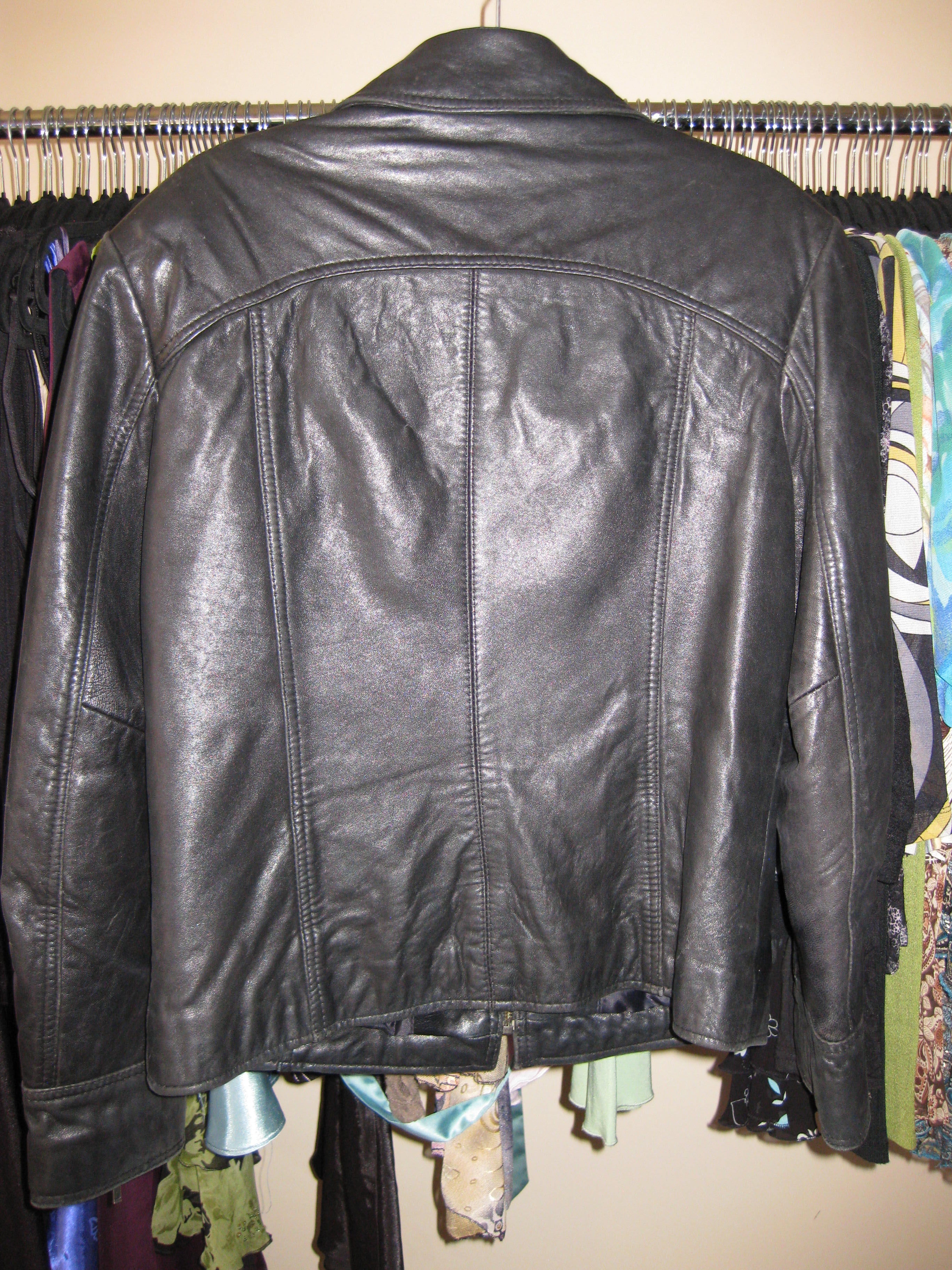 Leather jacket in black featuring arm zipper accents size 12