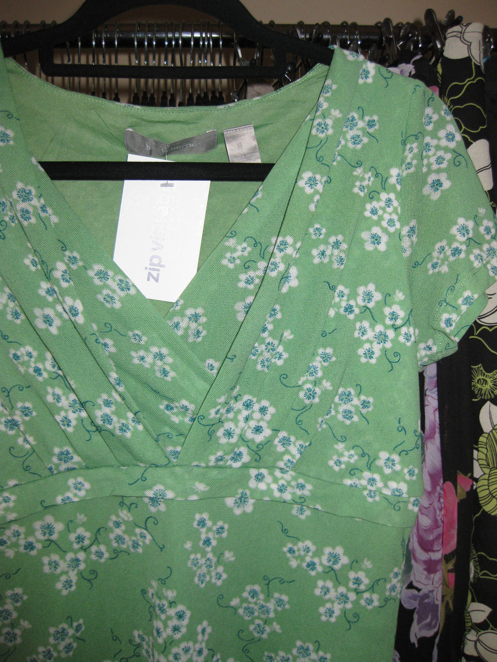 Green mesh top with wrap front and blue floral detail size M